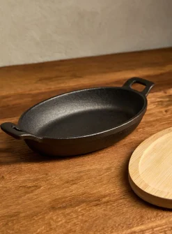 Small cast iron oval skillet with bamboo tray
