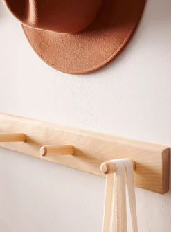Wall-mounted dowel coat rack